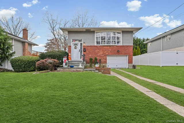 a front view of a house with a garden and plants