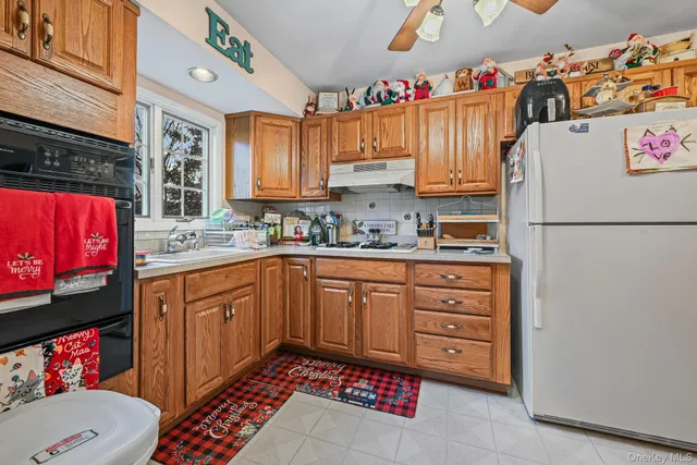 a kitchen with a refrigerator and a sink