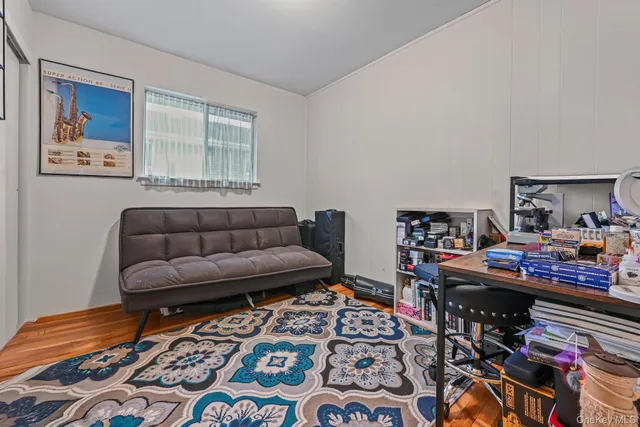 a bedroom with furniture and a flat screen tv
