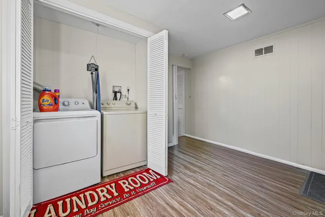 an empty room with wooden floor and closet