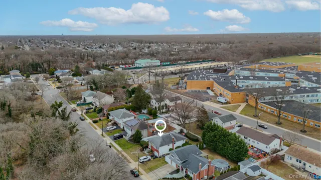 an aerial view of house with yard swimming pool and ocean view
