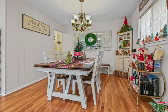 a view of a dining room with furniture wooden floor and chandelier