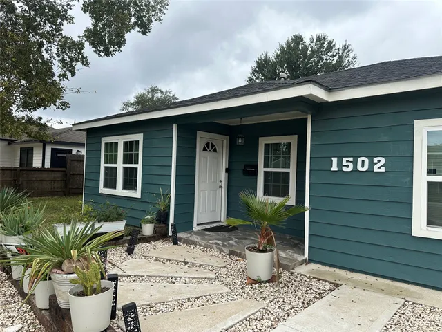 a view of a house with chair and potted plants