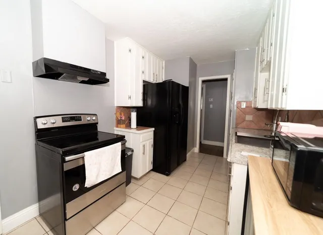 a kitchen with a refrigerator sink and stove