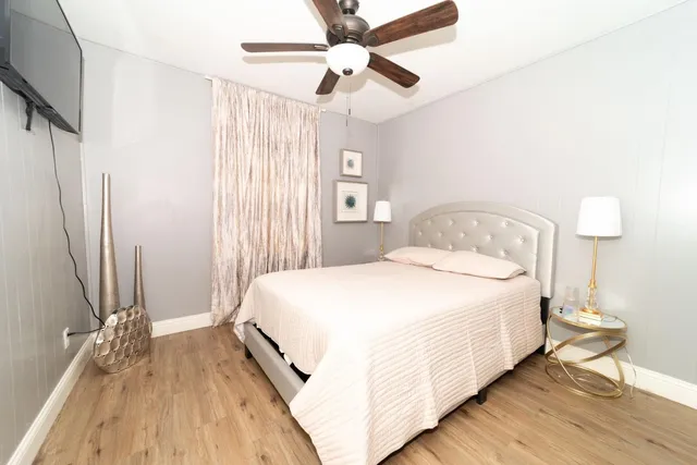 a bedroom with a bed and a chandelier