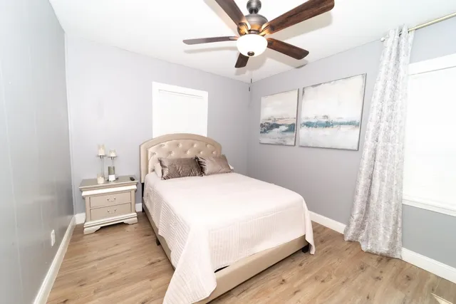 a bedroom with a bed and wooden floor
