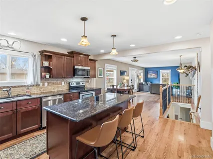 a kitchen with granite countertop lots of counter top space and stainless steel appliances