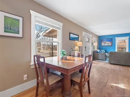a dining room with furniture and window