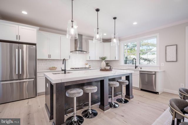 a kitchen with sink cabinets and stainless steel appliances