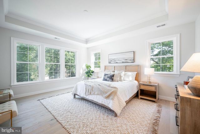 a spacious bedroom with a large bed and a window