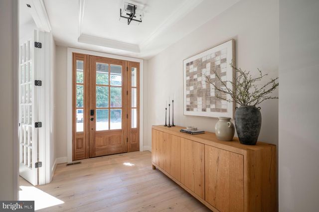 a living room with stainless steel appliances granite countertop furniture a fireplace and a large window