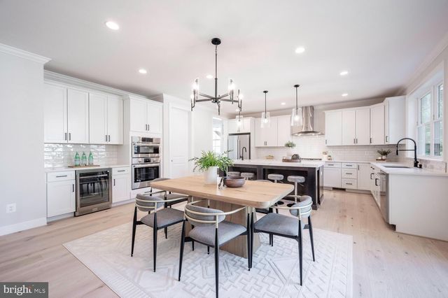 a kitchen with stainless steel appliances kitchen island granite countertop a sink and cabinets