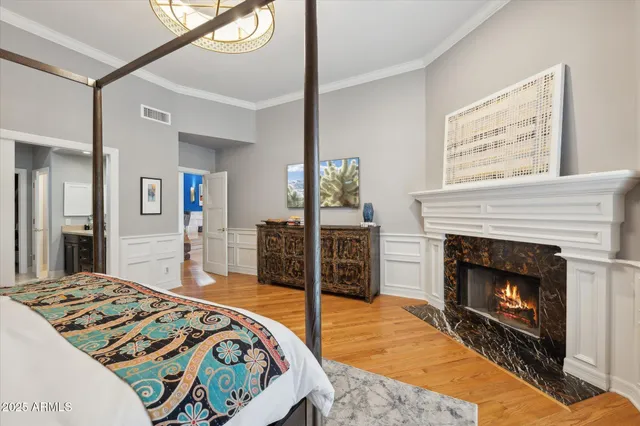 a bedroom with a bed and a fireplace
