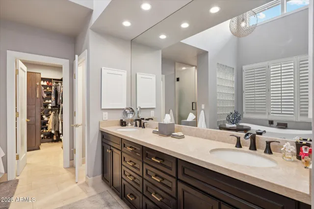 a bathroom with double vanity sinks double vanity and a tub