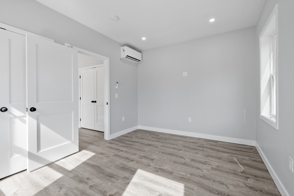 631 Franklin Street, Unit 209 Worcester, MA 01604 - Photo 14 of 42 wooden floor in an empty room with a window