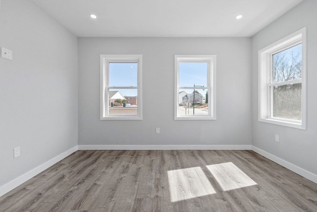 631 Franklin Street, Unit 209 Worcester, MA 01604 - Photo 17 of 42 a view of an empty room with wooden floor and a window