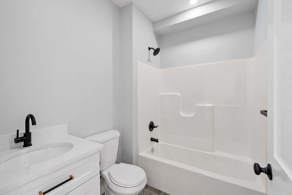631 Franklin Street, Unit 209 Worcester, MA 01604 - Photo 18 of 42 a bathroom with a sink a toilet and a bathtub