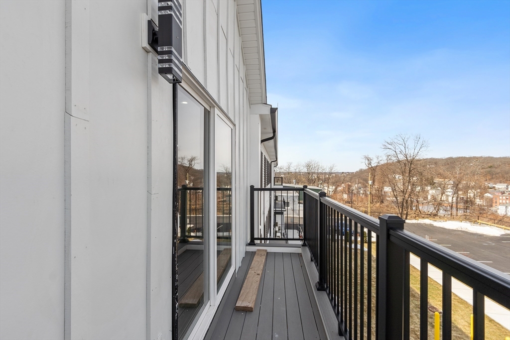 631 Franklin Street, Unit 209 Worcester, MA 01604 - Photo 23 of 42 a view of a balcony with wooden floor and city view