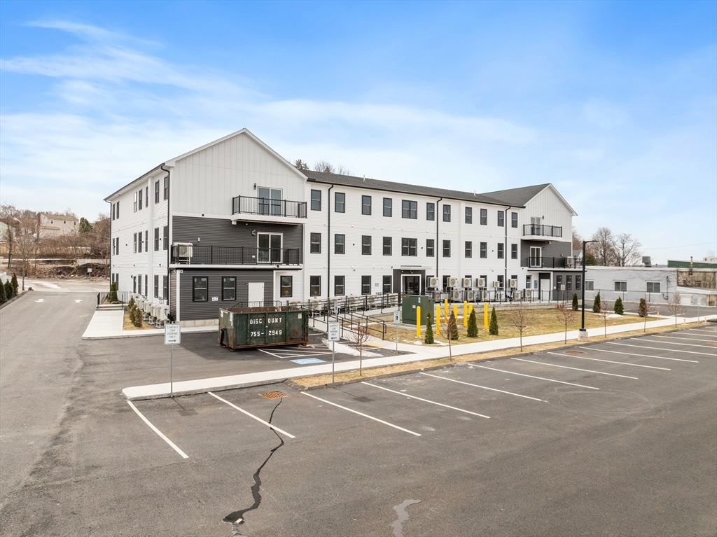 631 Franklin Street, Unit 209 Worcester, MA 01604 - Photo 31 of 42 a view of swimming pool with outdoor seating and house in the background