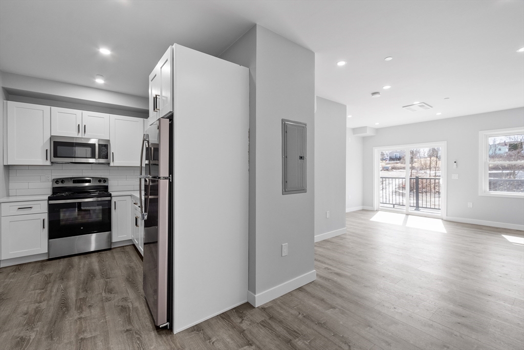 631 Franklin Street, Unit 209 Worcester, MA 01604 - Photo 4 of 42 a kitchen with stainless steel appliances a refrigerator and a stove top oven
