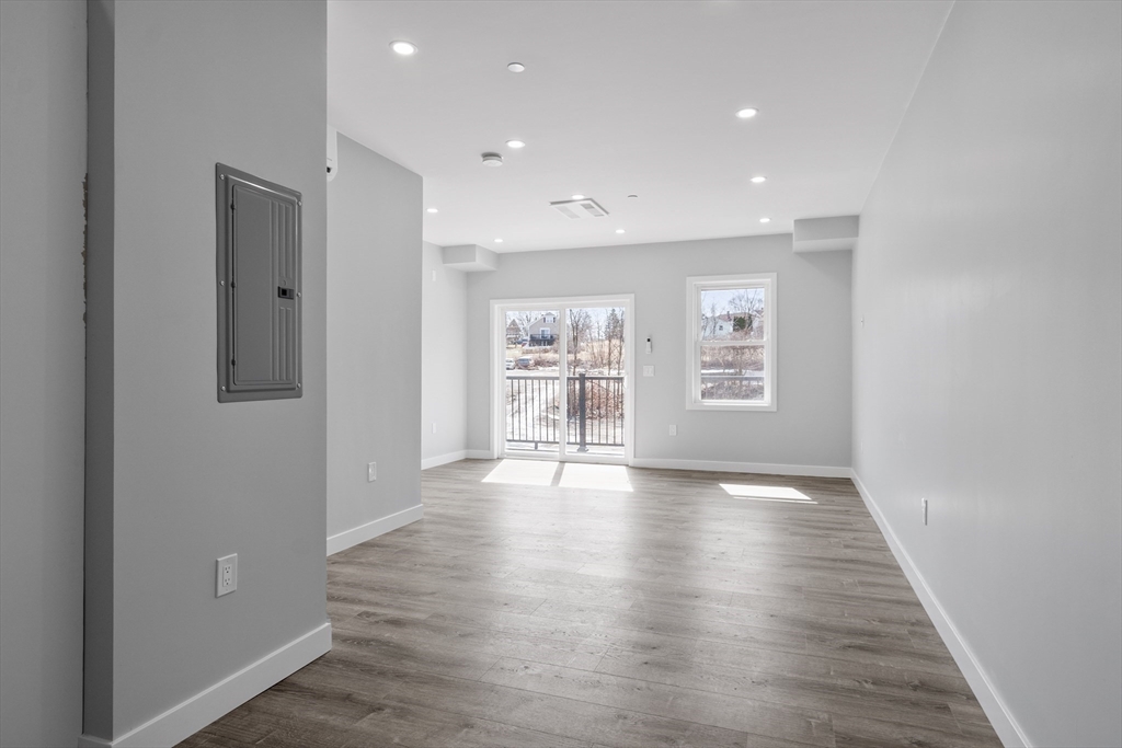 631 Franklin Street, Unit 209 Worcester, MA 01604 - Photo 9 of 42 a view of an empty room with a window and wooden floor