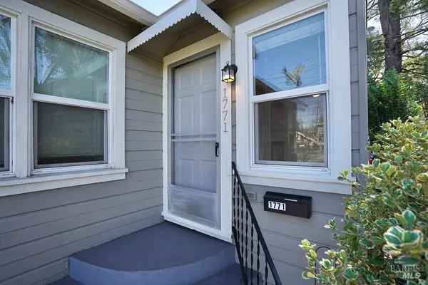 an aerial view of residential houses with city view