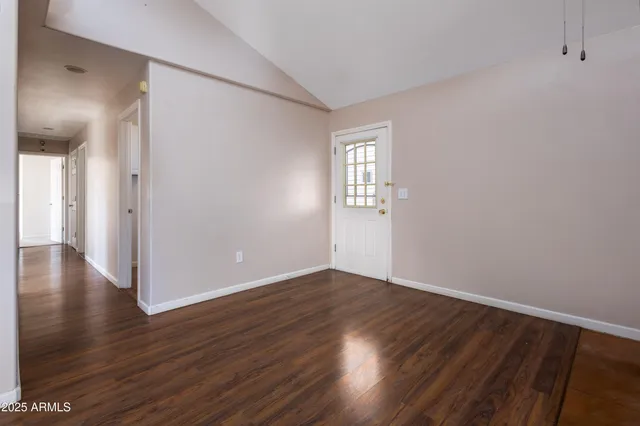 a dining room with furniture and wooden floor