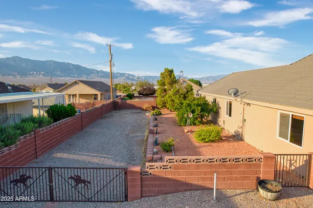 an empty room with windows and ceiling fan