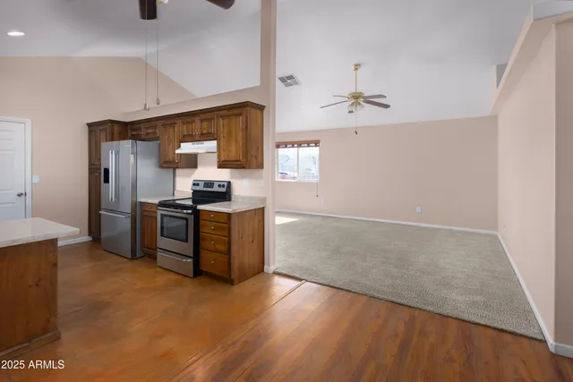 a kitchen with stainless steel appliances granite countertop a refrigerator and a stove