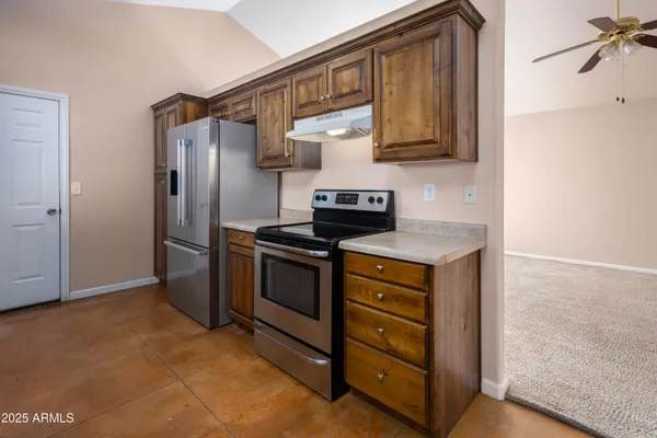 a kitchen with stainless steel appliances granite countertop a sink a microwave counter space and cabinets