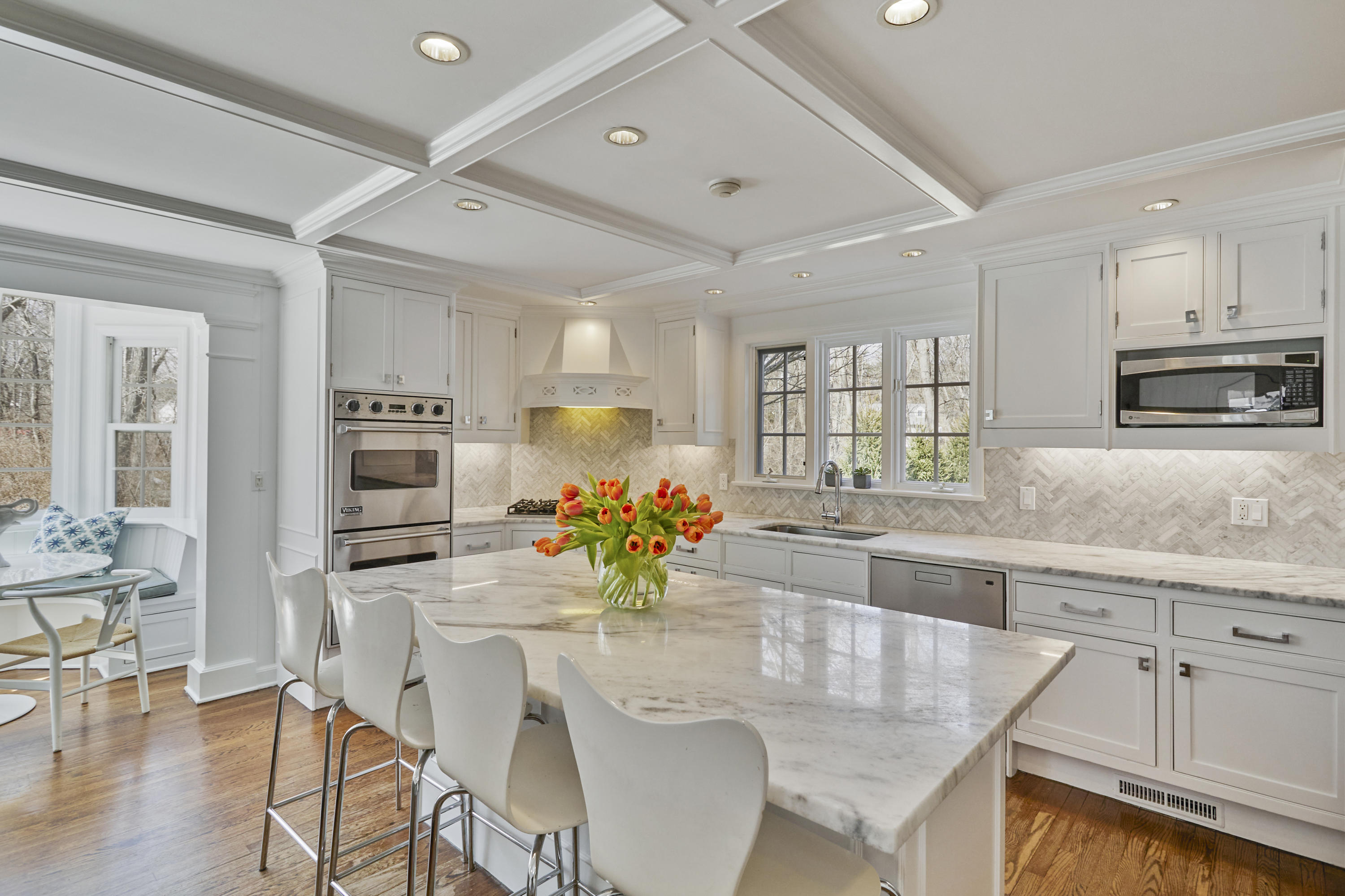5 Driftway Lane Darien, CT 06820 - Photo 15 of 46 a kitchen with stainless steel appliances kitchen island granite countertop a dining table chairs and granite counter tops