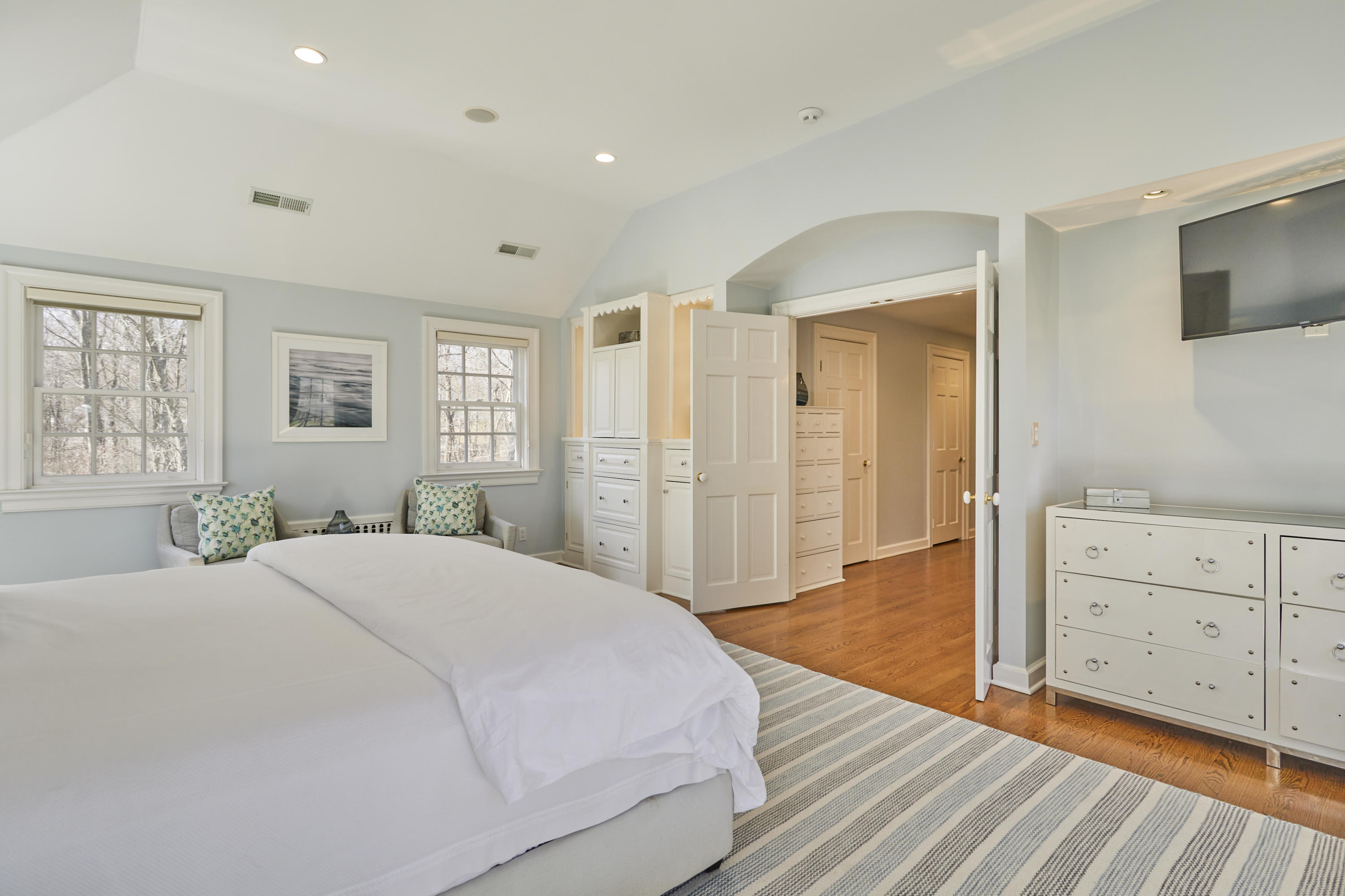 5 Driftway Lane Darien, CT 06820 - Photo 24 of 46 a spacious bedroom with a large bed and wooden floor