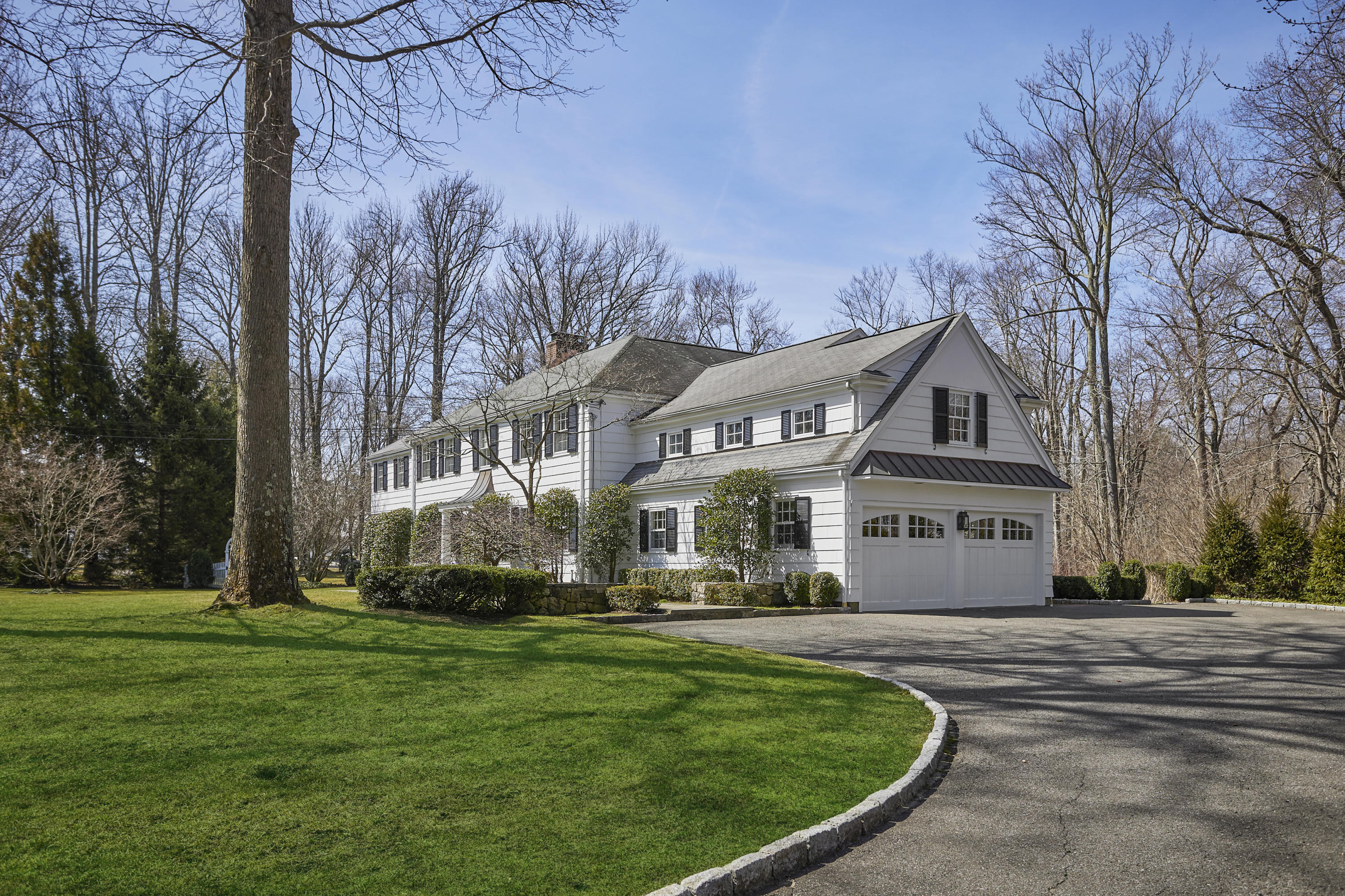 5 Driftway Lane Darien, CT 06820 - Photo 4 of 46 a front view of a house with a yard table and chairs