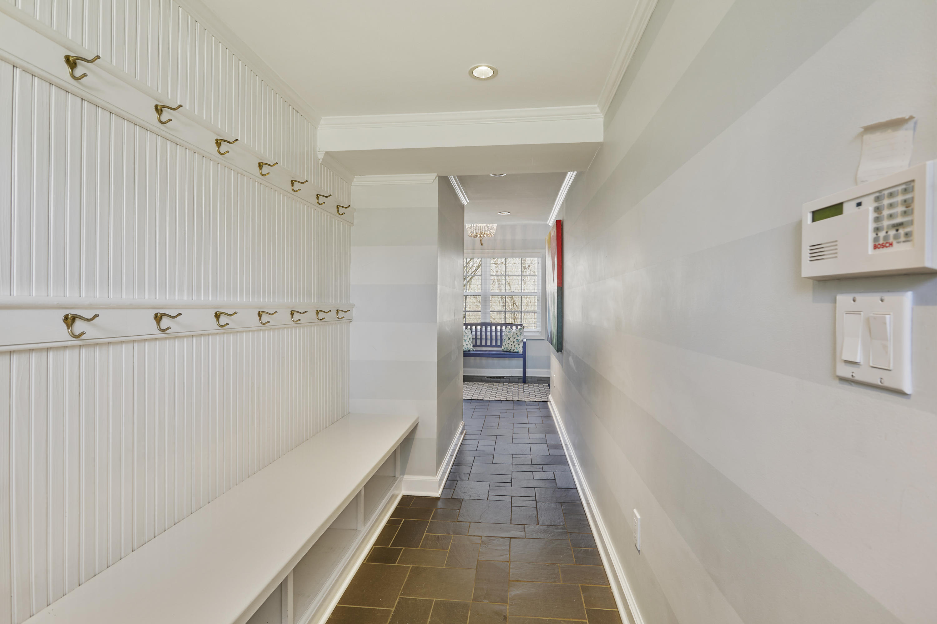 5 Driftway Lane Darien, CT 06820 - Photo 36 of 46 a hallway with a white cabinets and wooden floor