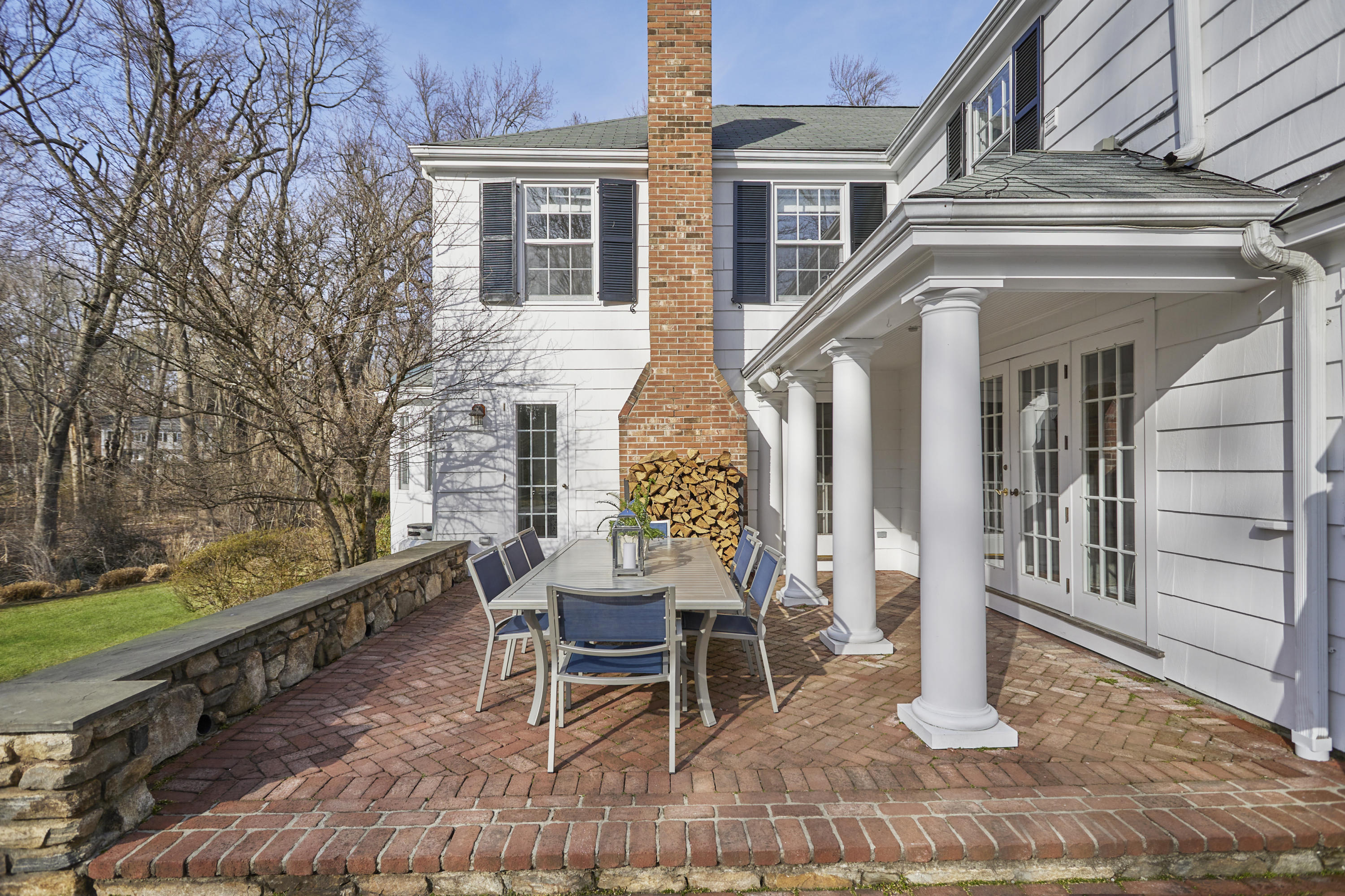 5 Driftway Lane Darien, CT 06820 - Photo 38 of 46 a view of a house with a chairs and table in the patio