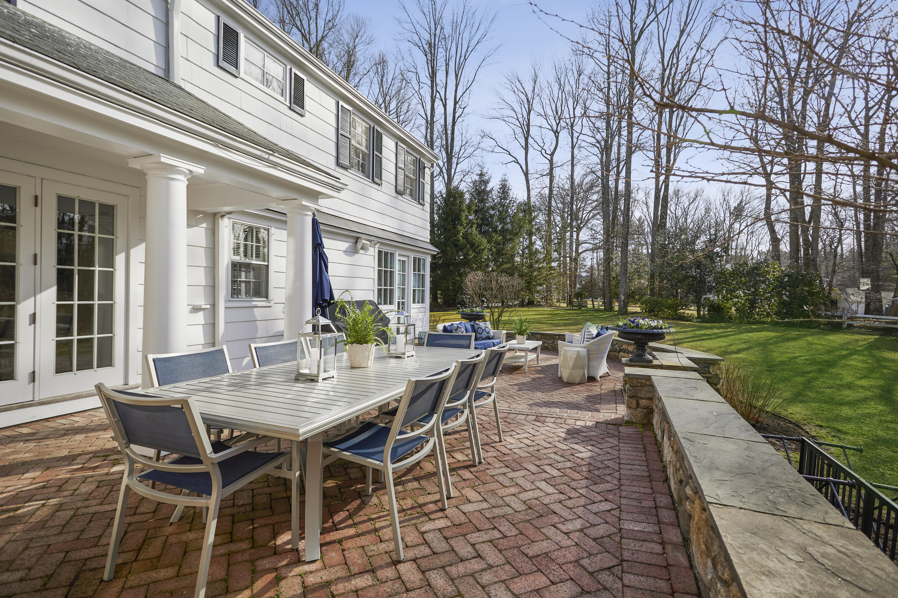 5 Driftway Lane Darien, CT 06820 - Photo 40 of 46 a view of a patio with table and chairs and garden