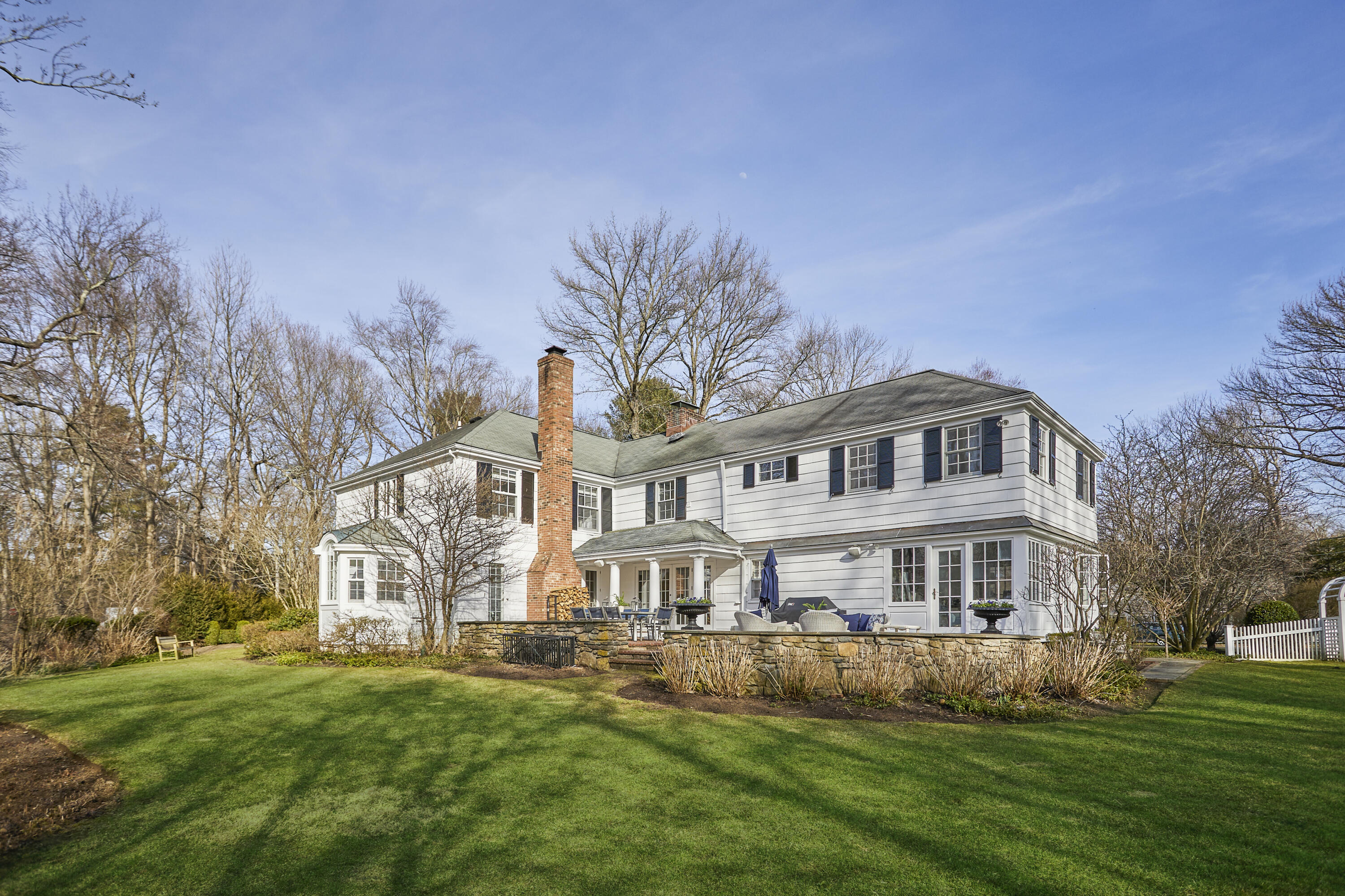 5 Driftway Lane Darien, CT 06820 - Photo 41 of 46 a front view of a house with a garden