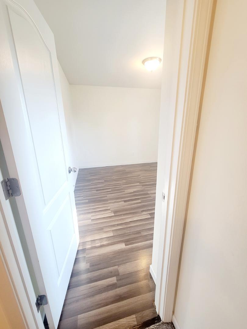 5423 Big Bass Drive Raleigh, NC 27610 - Photo 18 of 42 a view of staircase with white walls and white door