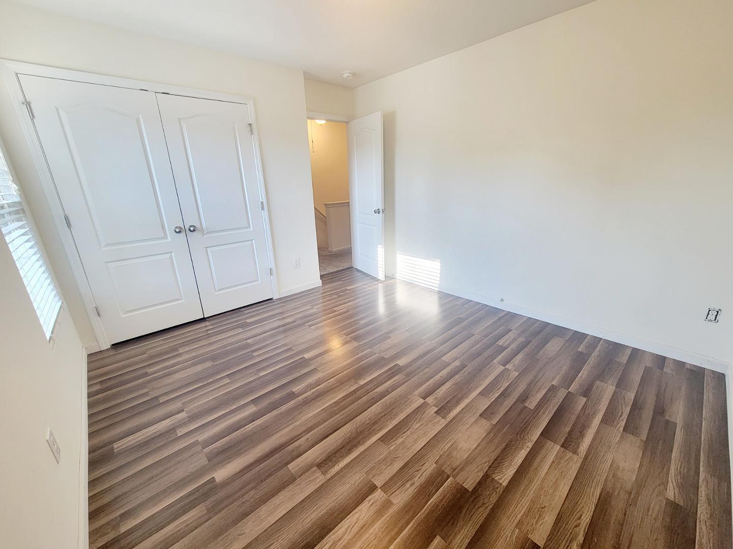 5423 Big Bass Drive Raleigh, NC 27610 - Photo 21 of 42 a view of an empty room with wooden floor
