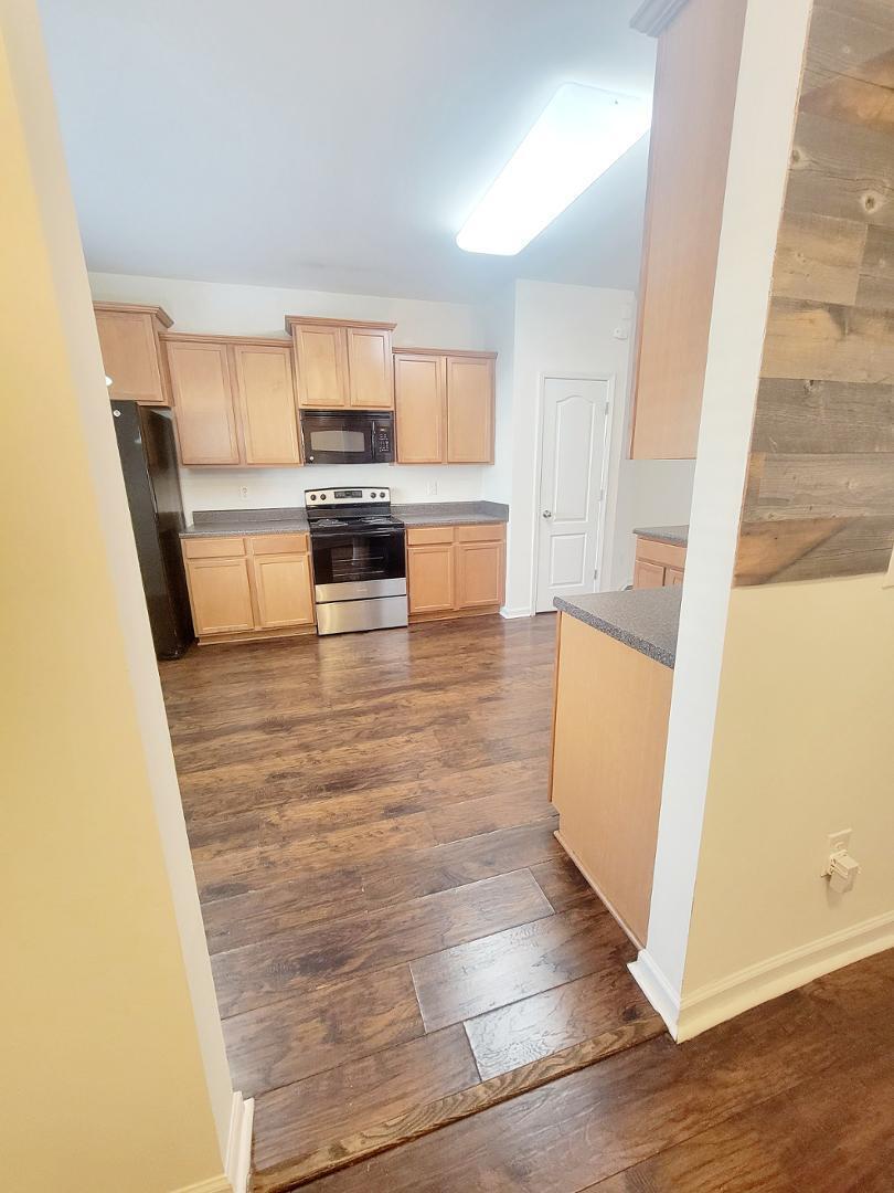 5423 Big Bass Drive Raleigh, NC 27610 - Photo 3 of 42 a view of a kitchen with wooden floor