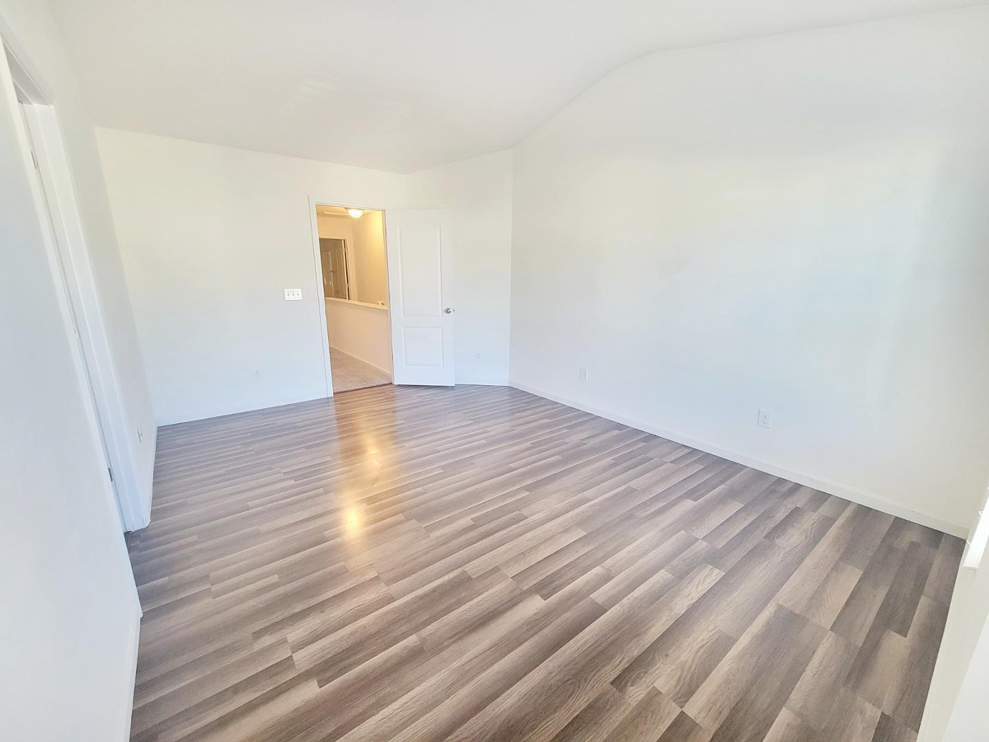 5423 Big Bass Drive Raleigh, NC 27610 - Photo 35 of 42 a view of an empty room with wooden floor