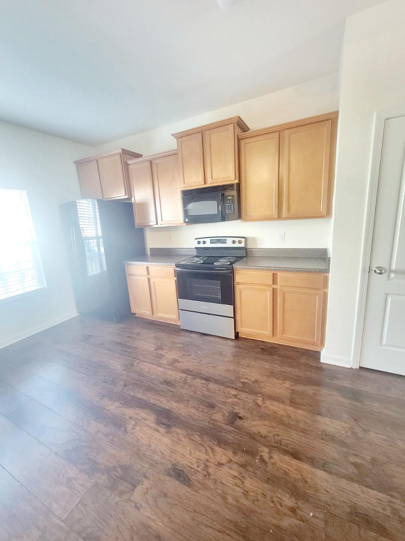 5423 Big Bass Drive Raleigh, NC 27610 - Photo 7 of 42 a kitchen with granite countertop a stove and a sink