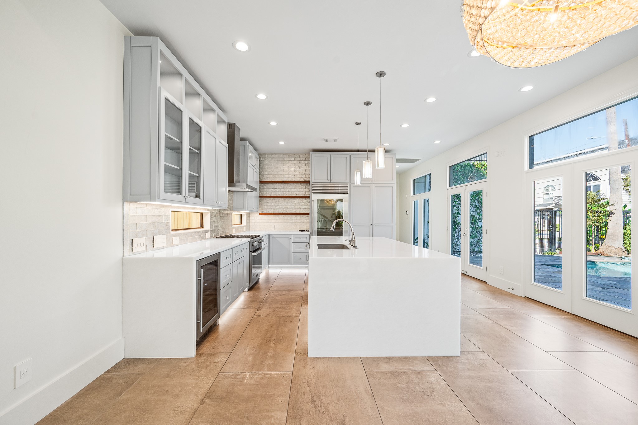 235 Malone Street Houston, TX 77007 - Photo 19 of 46 a large white kitchen with a large window and stainless steel appliances