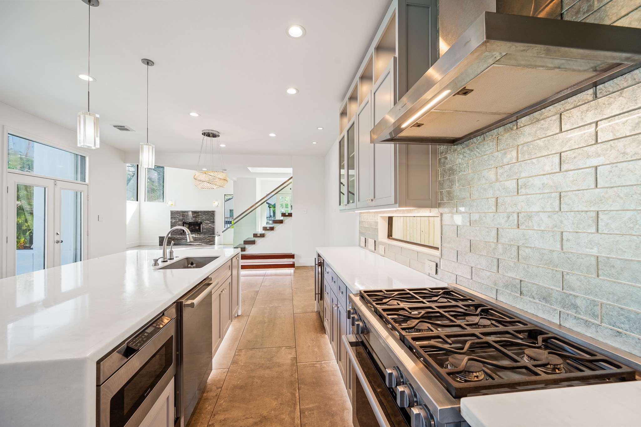 235 Malone Street Houston, TX 77007 - Photo 20 of 46 a kitchen with kitchen island a counter space a sink a stove and wooden floors