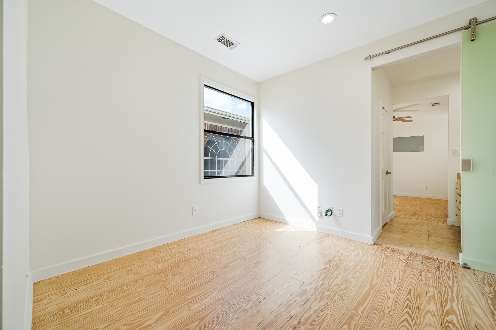 235 Malone Street Houston, TX 77007 - Photo 23 of 46 an empty room with wooden floor and windows
