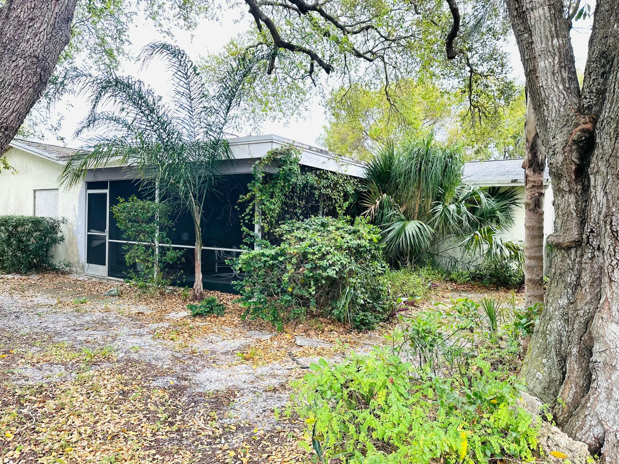 679 Southwest 17th Court Boca Raton, FL 33486 - Photo 5 of 6 a view of a backyard with plants and large trees