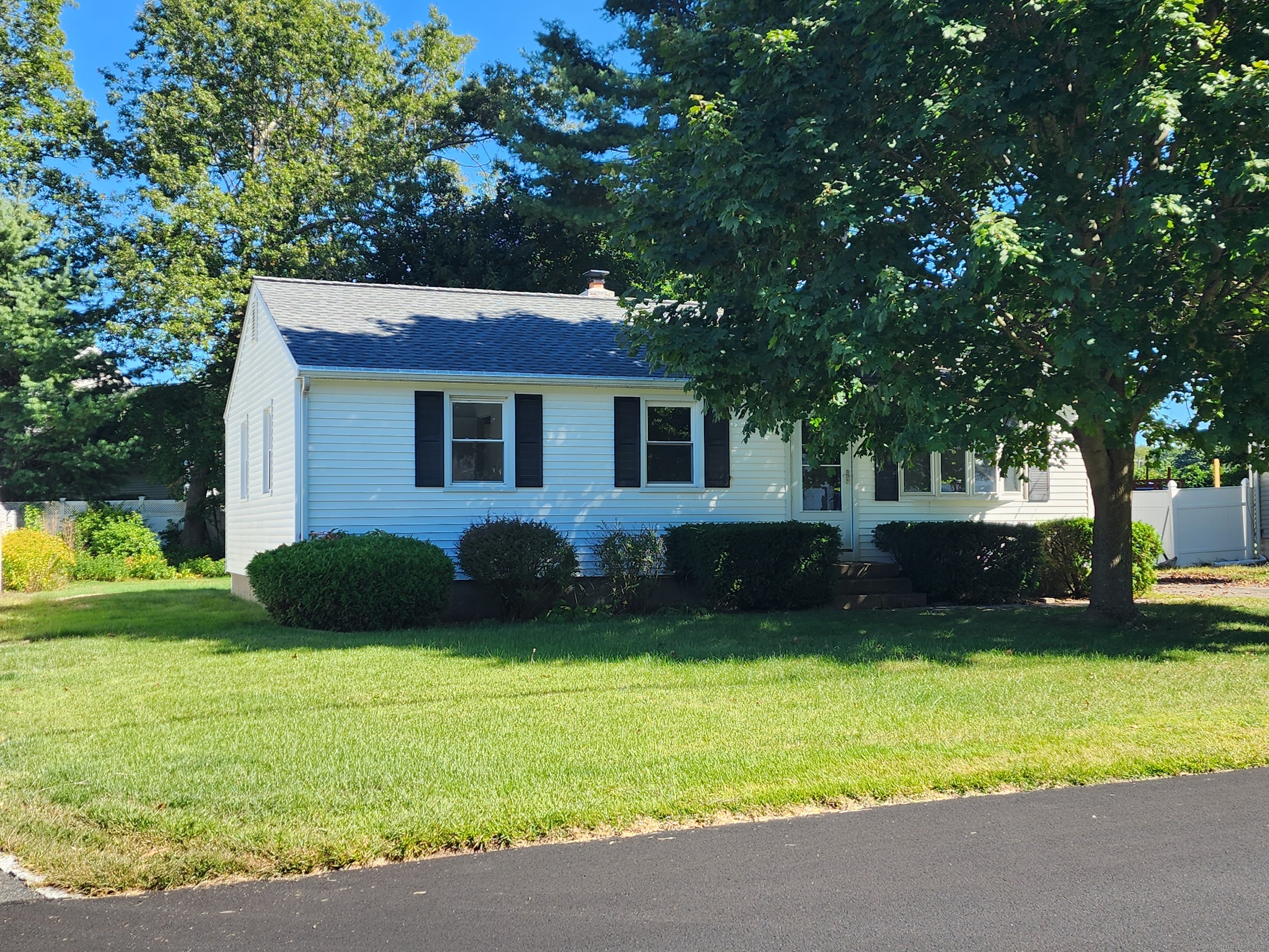 a view of house with backyard and garden