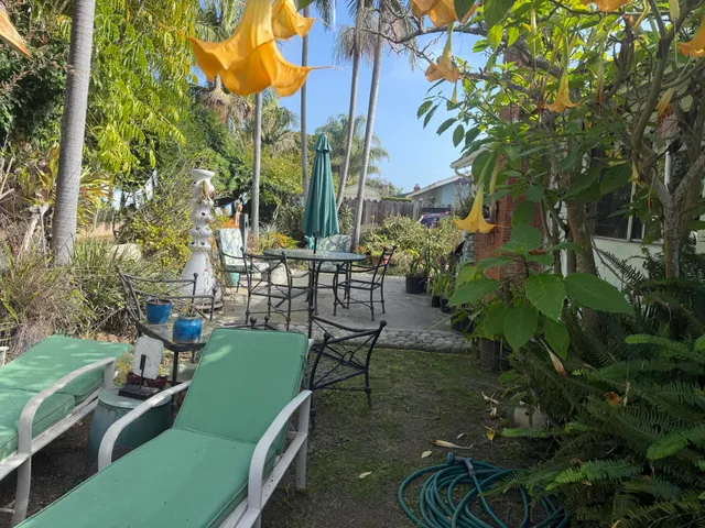 a view of a chair and table in the garden
