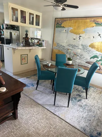 a living room with table chairs and a dining table