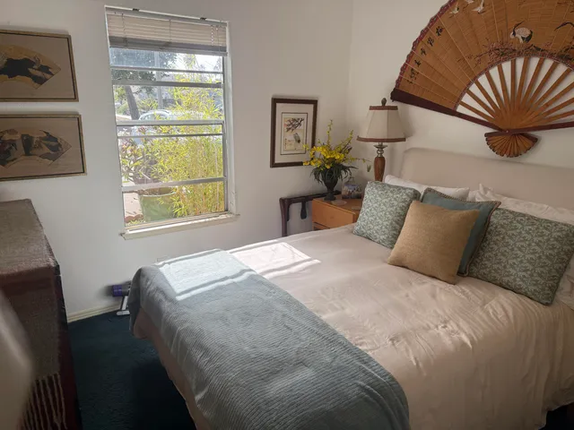 a bedroom with a bed and window